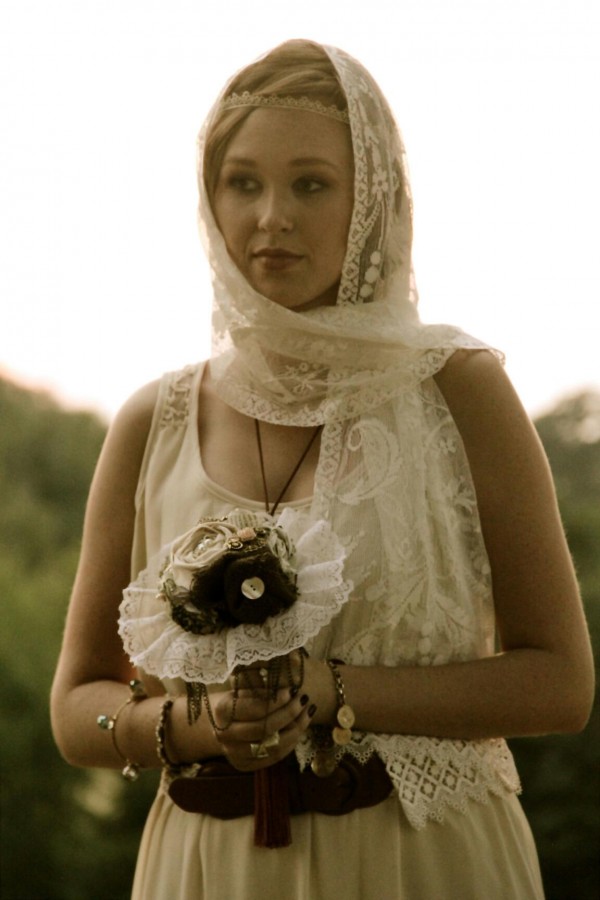 bohemian princess holds embellished bouquet